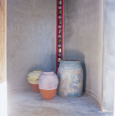 
Ron's handiwork graces the open stairwell of the beach home. The 'lipstick' column (so-called for its color) with its 'bicycle chain' allows ventilation and light to penetrate the stairwell.
